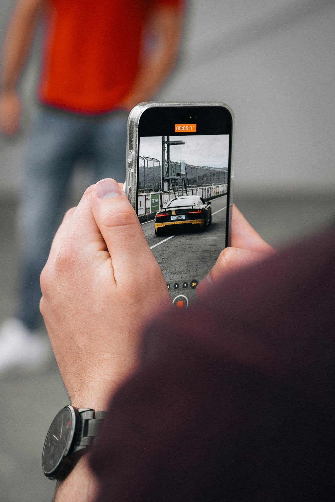 Person photographing a car with a smartphone